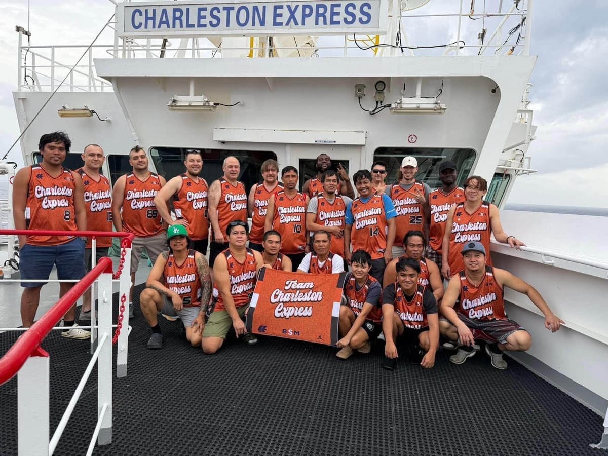 Charleston Express crew in orange jerseys on the deck of their ship