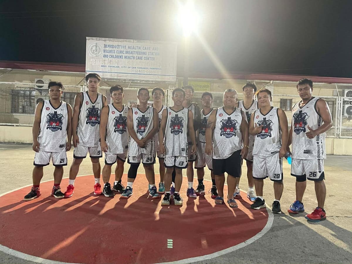 G1 Warriors team in white and black jerseys on a covered court at night